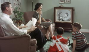 a family watching a television showing how entertainment shapes the American culture 