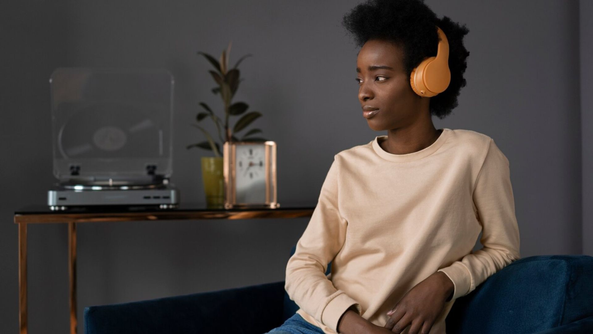 a lady sitting listening to music with her headphones 